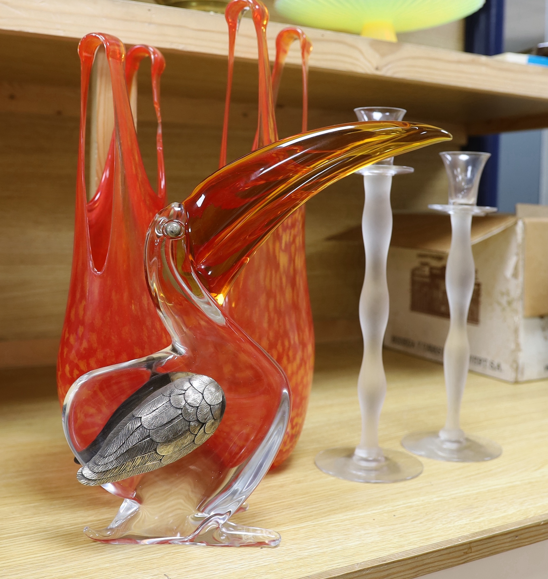Art glassware comprising of two orange Kosta Boda glass vases, a novelty glass pelican ornament and a pair of glass candlesticks (5), the largest 47cm high